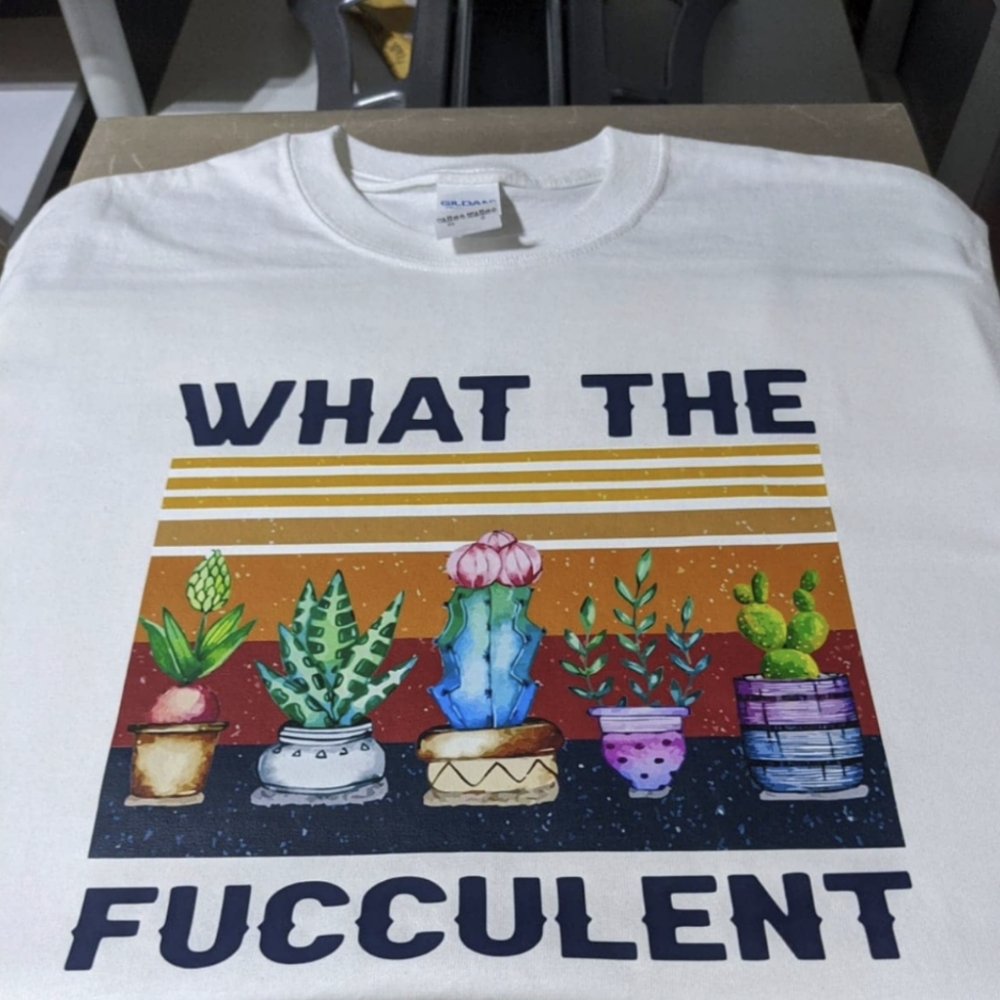 White t-shirt with cactus printed on it